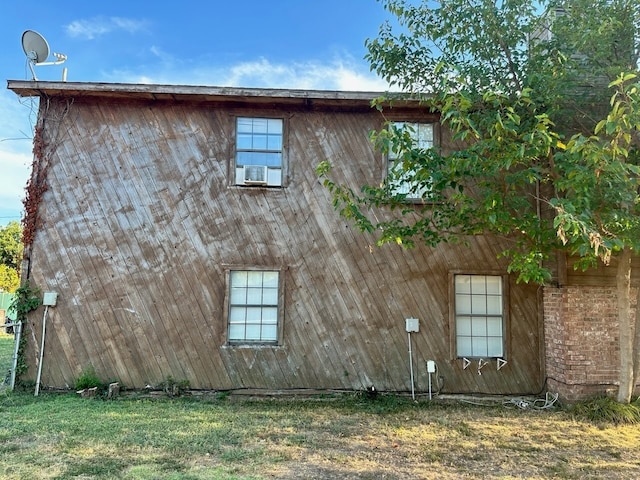 view of property exterior featuring cooling unit and a yard