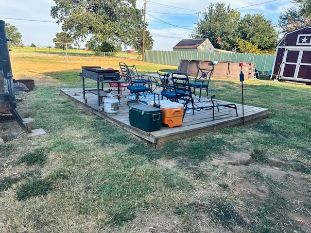 exterior space with a wooden deck and a storage unit