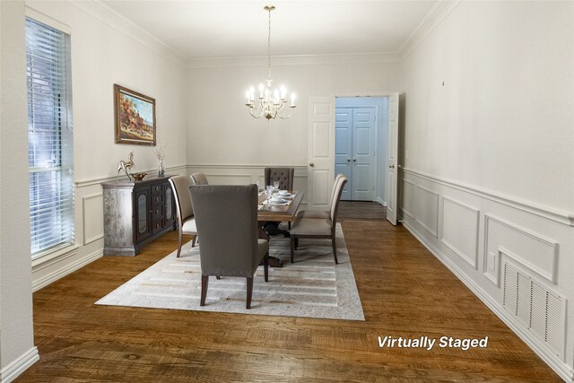 dining area with a chandelier, dark hardwood / wood-style floors, and crown molding