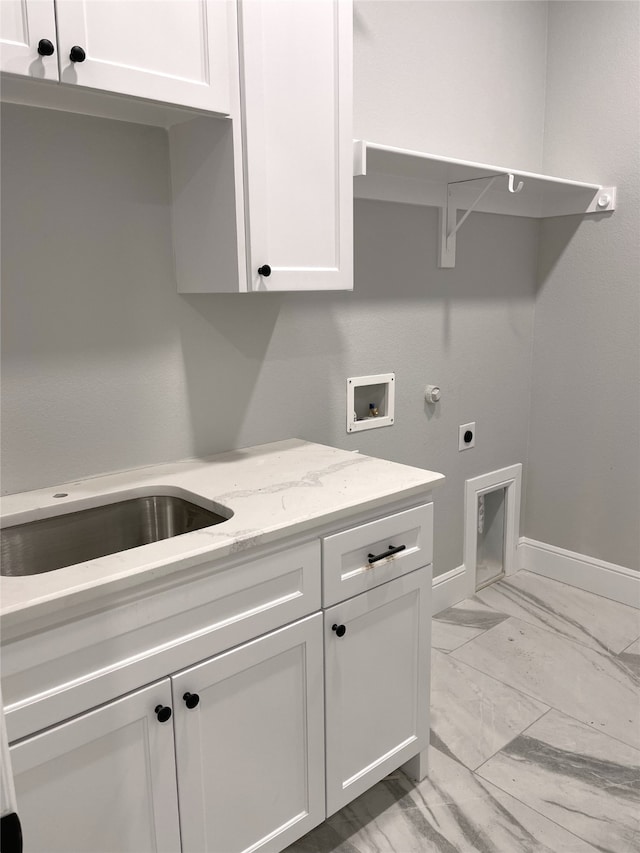 clothes washing area with hookup for an electric dryer, sink, hookup for a washing machine, and cabinets