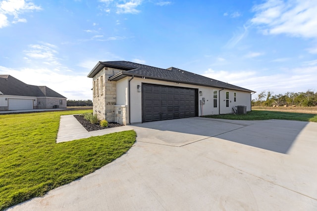 view of property exterior featuring central AC, a garage, and a yard