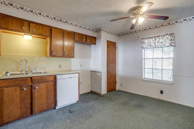 kitchen featuring sink, a textured ceiling, white dishwasher, dark carpet, and ceiling fan