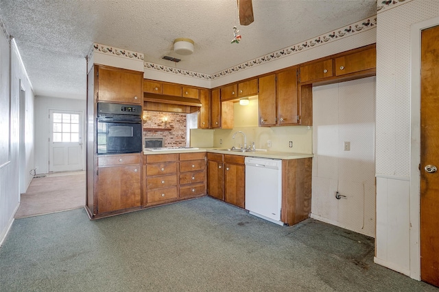 kitchen featuring sink, white dishwasher, a textured ceiling, dark carpet, and oven