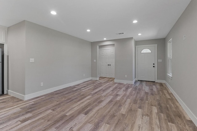 foyer entrance with light hardwood / wood-style floors