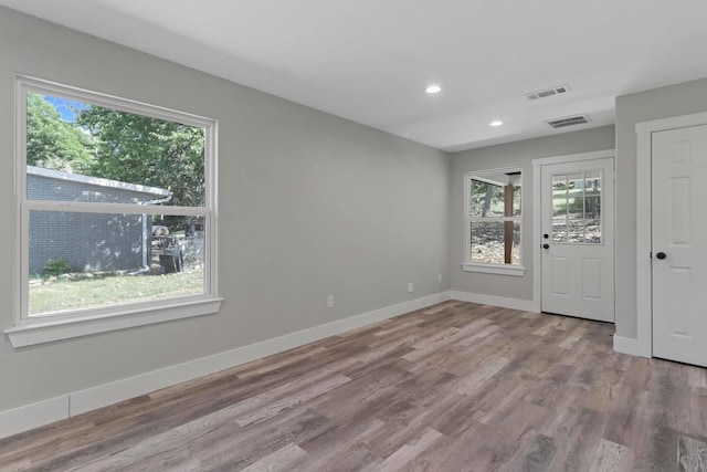 spare room featuring hardwood / wood-style floors and a wealth of natural light