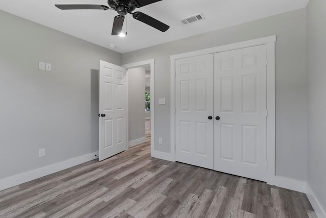 unfurnished bedroom with a closet, ceiling fan, and hardwood / wood-style floors