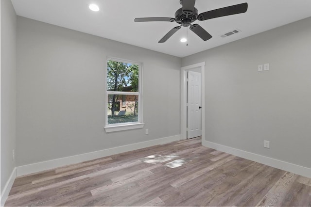 spare room featuring ceiling fan and light hardwood / wood-style floors