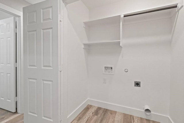 laundry area with electric dryer hookup, light hardwood / wood-style flooring, washer hookup, and gas dryer hookup