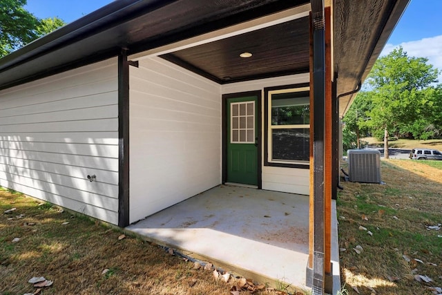 view of exterior entry featuring a patio area and cooling unit