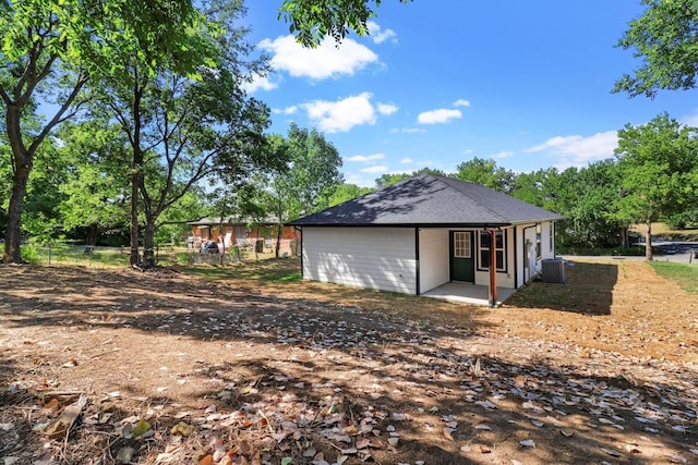 exterior space with central air condition unit and a patio