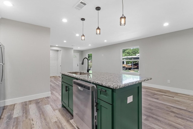 kitchen featuring sink, dishwasher, a kitchen island with sink, and light wood-type flooring