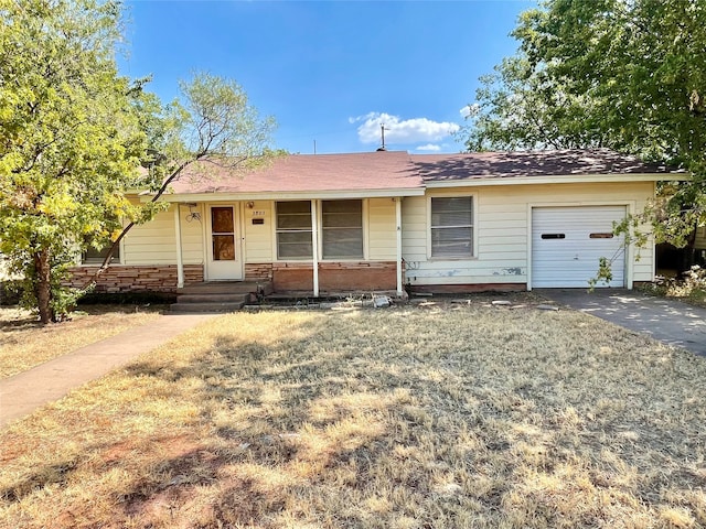 single story home with a garage and covered porch