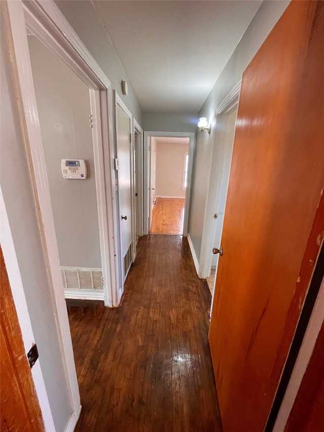 hall with dark hardwood / wood-style flooring