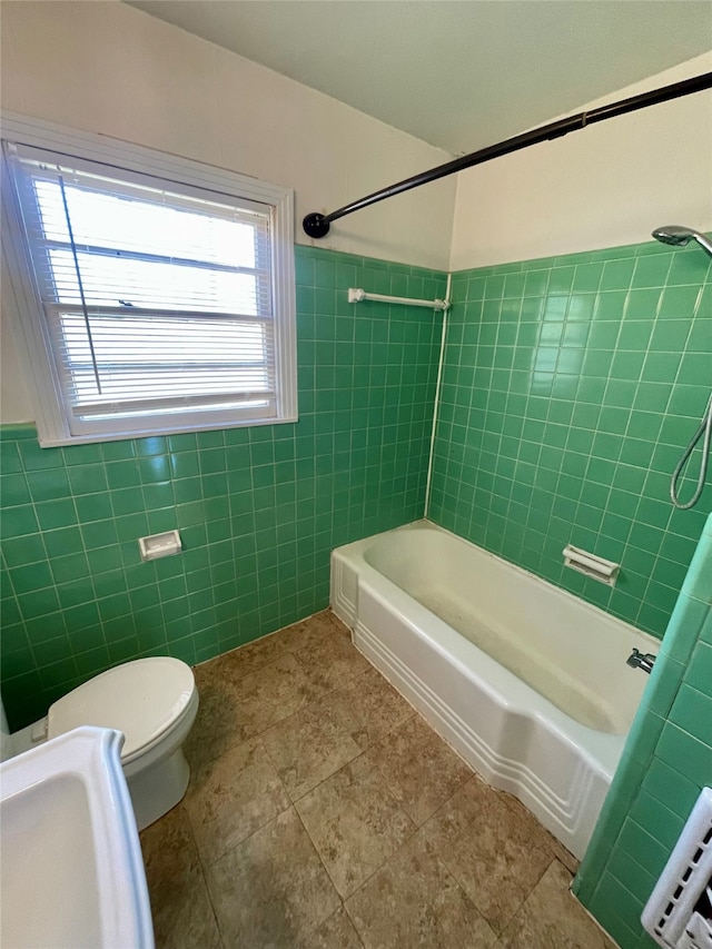 bathroom featuring plenty of natural light, toilet, and tile patterned floors