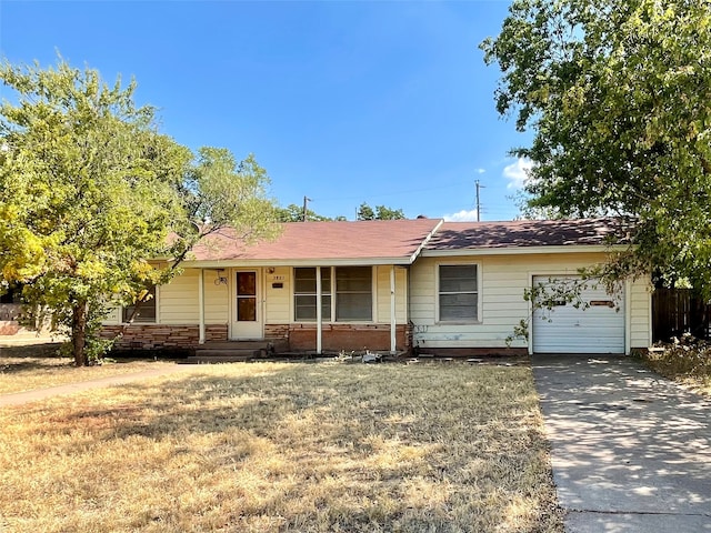 single story home featuring a garage, a front lawn, and covered porch