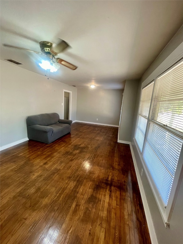 interior space with ceiling fan and wood-type flooring