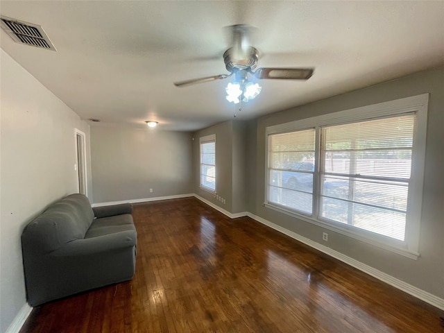 living area with ceiling fan and hardwood / wood-style flooring