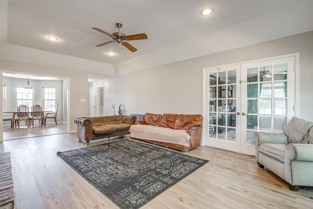 living room featuring ceiling fan, light wood-type flooring, and french doors