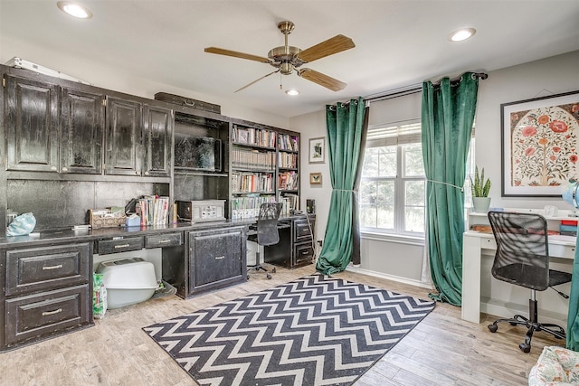 office with ceiling fan, light wood-type flooring, and built in desk