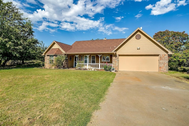 ranch-style home with covered porch, a garage, and a front yard