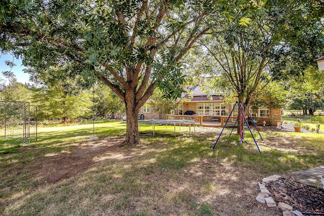 view of yard with a wooden deck and a playground