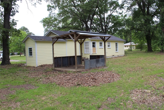 back of property featuring a yard