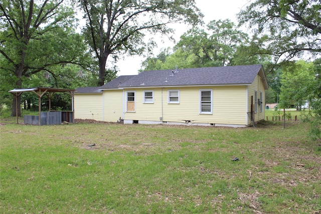 back of property with a lawn