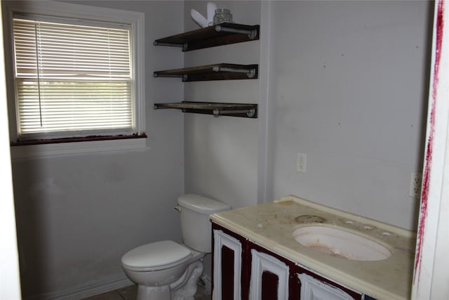 929 Forsythe St, Carthage, TX 75633 - half bath featuring vanity, toilet, tile patterned flooring, and baseboards