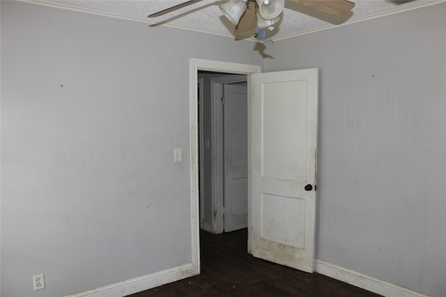 empty room with ceiling fan, hardwood / wood-style floors, crown molding, and a textured ceiling