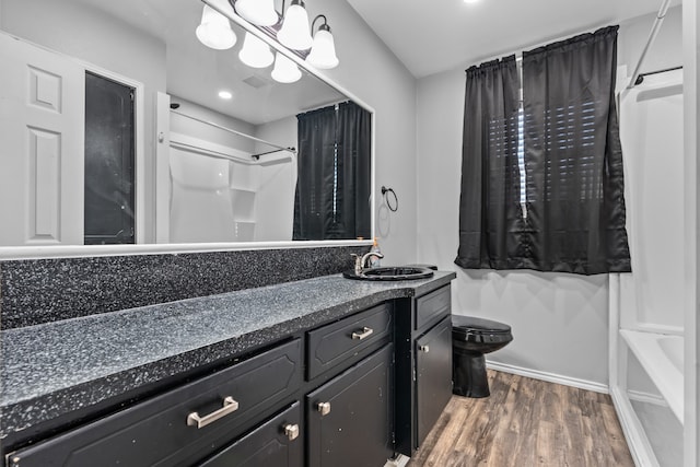 full bathroom with hardwood / wood-style flooring, shower / bathtub combination, toilet, and vanity