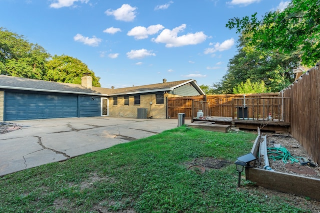 view of yard with a garage and a deck