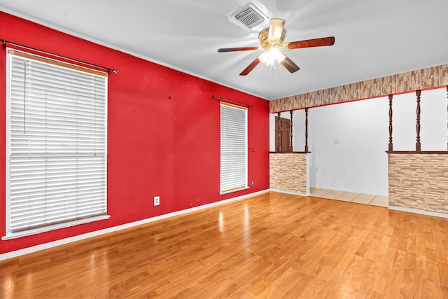 empty room with light wood-type flooring and ceiling fan