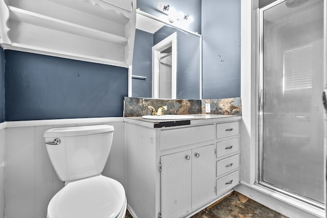 bathroom with a shower with door, toilet, tile patterned floors, and vanity