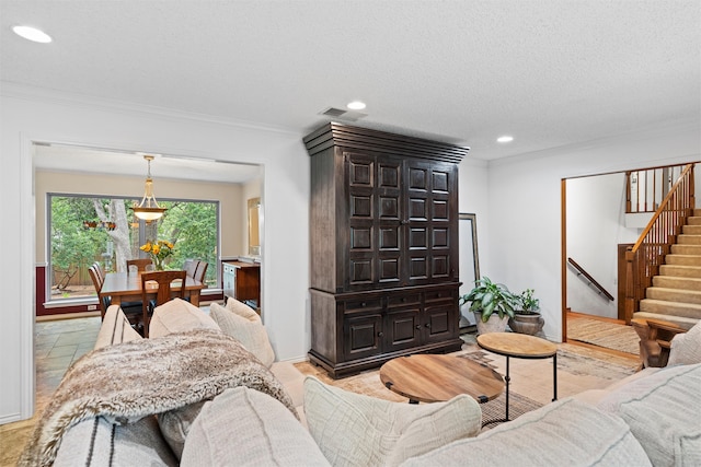 tiled living room with a textured ceiling and crown molding