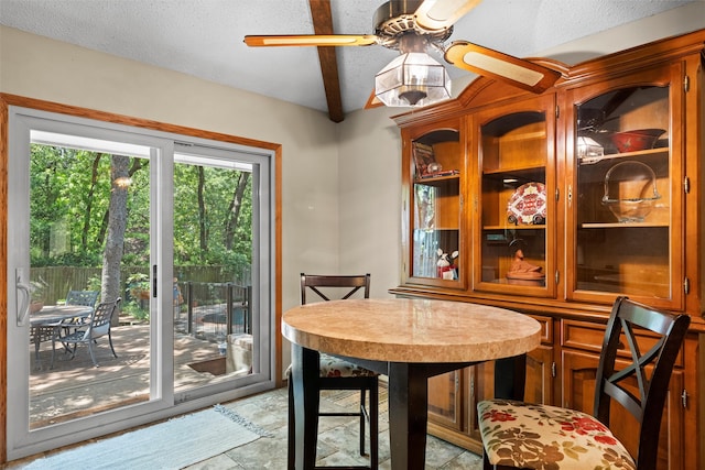 dining space with a textured ceiling, ceiling fan, and light tile patterned flooring