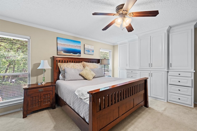 carpeted bedroom featuring ceiling fan, ornamental molding, and a textured ceiling