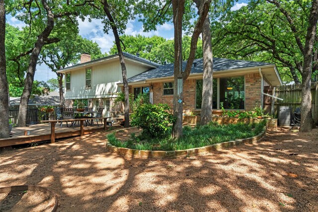 back of house with a wooden deck