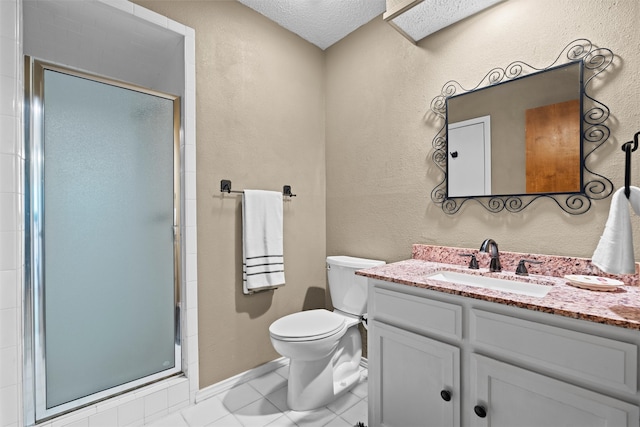 bathroom featuring toilet, an enclosed shower, vanity, tile patterned floors, and a textured ceiling