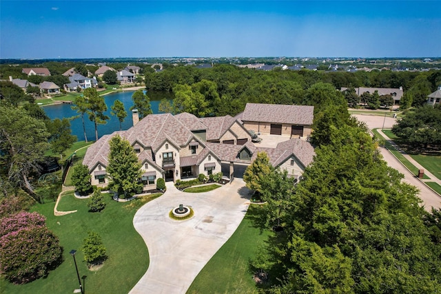 drone / aerial view with a residential view and a water view