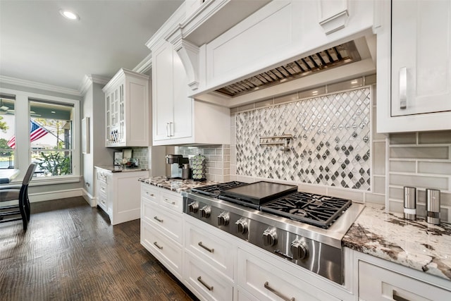 kitchen featuring white cabinets, ornamental molding, light stone counters, premium range hood, and stainless steel gas cooktop