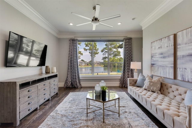 living room featuring dark wood-style floors, crown molding, baseboards, and a ceiling fan