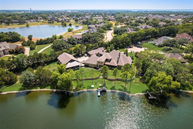 drone / aerial view with a residential view and a water view