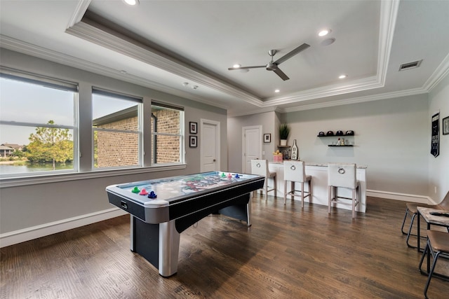 game room featuring ceiling fan, wood finished floors, visible vents, baseboards, and a tray ceiling