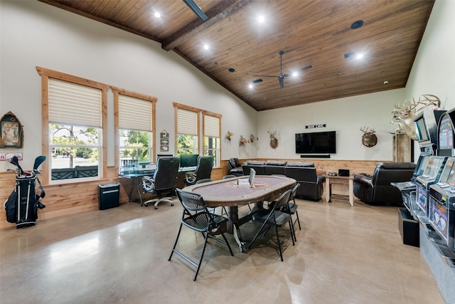 dining space featuring concrete flooring, high vaulted ceiling, a wainscoted wall, wood walls, and wood ceiling