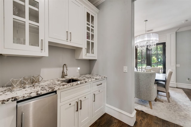 kitchen featuring dark wood-style flooring, white cabinetry, stainless steel dishwasher, light stone countertops, and an inviting chandelier