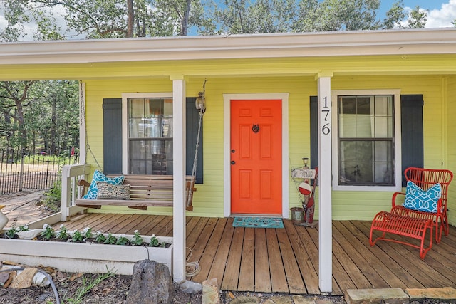 view of exterior entry with a porch