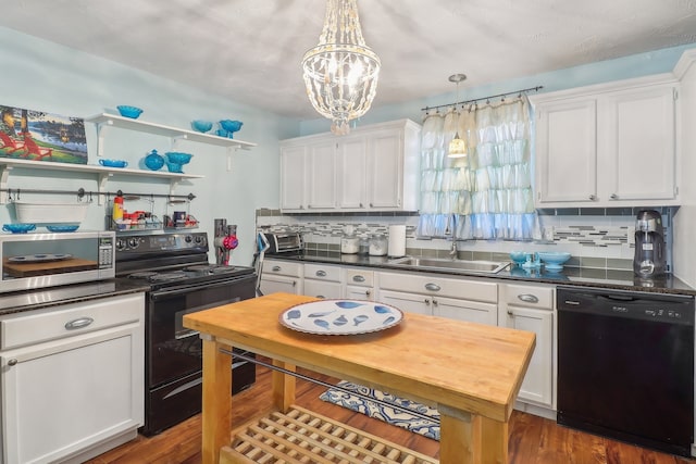 kitchen featuring decorative backsplash, pendant lighting, white cabinets, sink, and black appliances