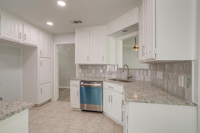 kitchen featuring visible vents, a sink, stainless steel dishwasher, and white cabinetry