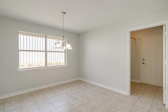 unfurnished room featuring a chandelier, light tile patterned flooring, and baseboards