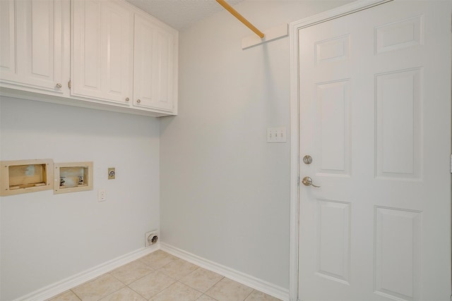 laundry area with hookup for a washing machine, cabinet space, hookup for an electric dryer, light tile patterned flooring, and baseboards